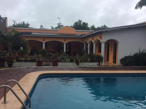 a house with a swimming pool in front of it at Hotel Quinta Valentina in Ahuacatlán