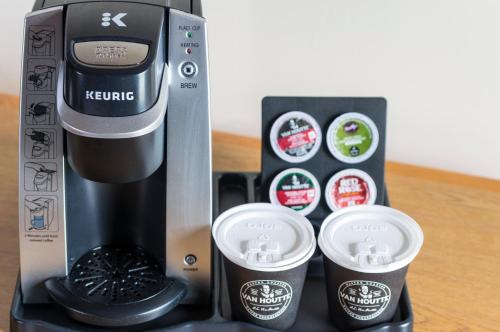 a coffee maker and two cups on a table at Mount Peyton Resort & Conference Centre in Grand Falls -Windsor