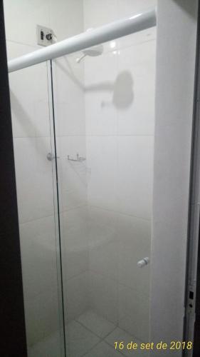 a shower with a glass door in a bathroom at Kontiki Hotel in São Francisco do Sul
