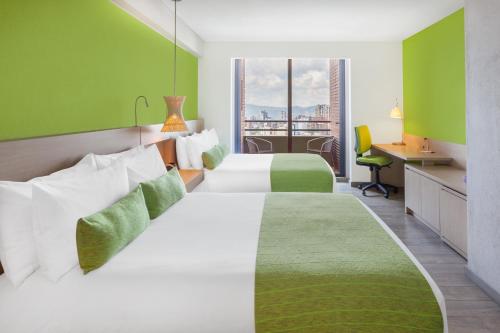 Säng eller sängar i ett rum på Hotel Bari Bucaramanga