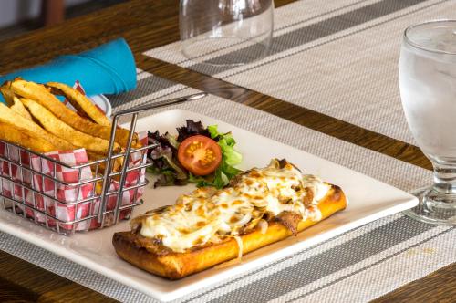 a plate of food with a hot dog and french fries at Mount Peyton Resort & Conference Centre in Grand Falls -Windsor