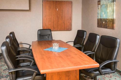 a conference room with a wooden table and chairs at Mount Peyton Resort & Conference Centre in Grand Falls -Windsor