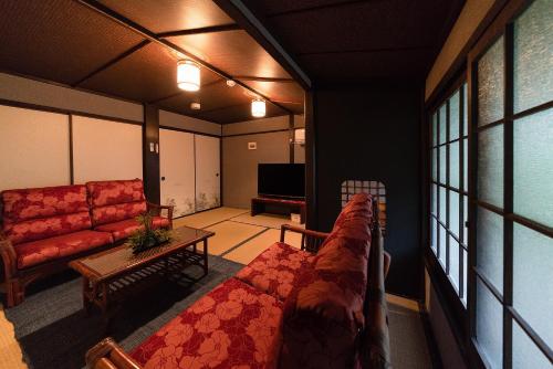 a living room with a couch and a table at Yurakuan - Awagami Residence Inn in Kyoto