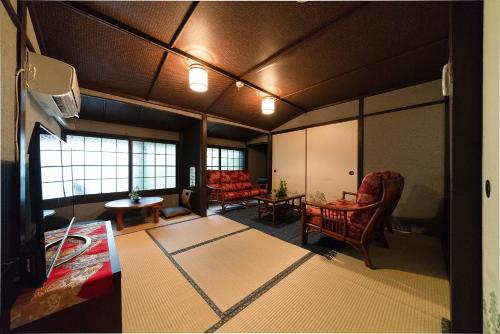 a living room with chairs and a table in a room at Yurakuan - Awagami Residence Inn in Kyoto