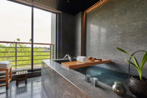 a bathroom with a sink and a large window at Apexvilla-moon in Dongshan
