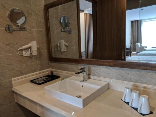a bathroom with a sink and a mirror at Muong Thanh Luxury Son La in Sơn La