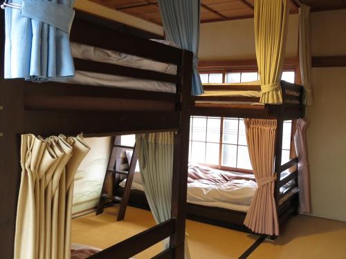 Postel nebo postele na pokoji v ubytování Guest house Roji to Akari
