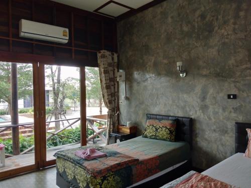 Кровать или кровати в номере Ingaun Resort Kanchanaburi