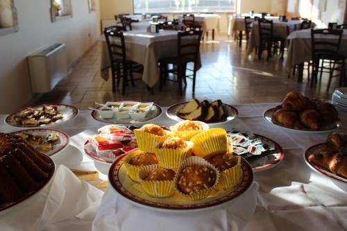 a table filled with different types of pastries and bread at Masseria Chinunno in Altamura