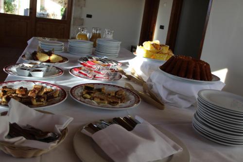 a table with plates of food on top at Masseria Chinunno in Altamura