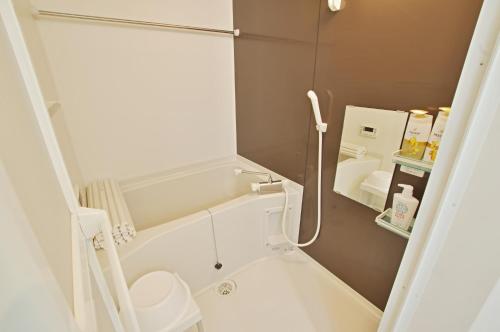 a bathroom with a shower with a toilet and a sink at White Sand Beach Enoshima in Kamakura