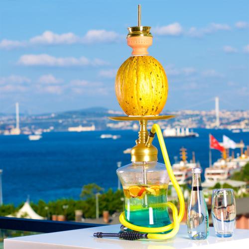 a drink dispenser on a table with a view of the ocean at Glamour Hotel Istanbul Sirkeci in Istanbul