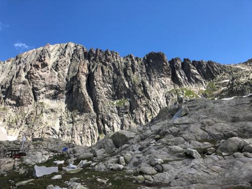 a large rocky mountain in front of a blue sky at Chalet Maso Pino in Castello Tesino