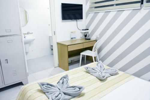 Кровать или кровати в номере Alicia Tower Residences