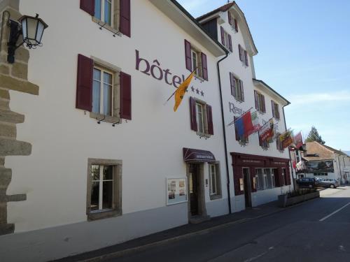 a building on the side of a street at Hôtel du Port - Free Parking - Breakfast included in Estavayer-le-Lac