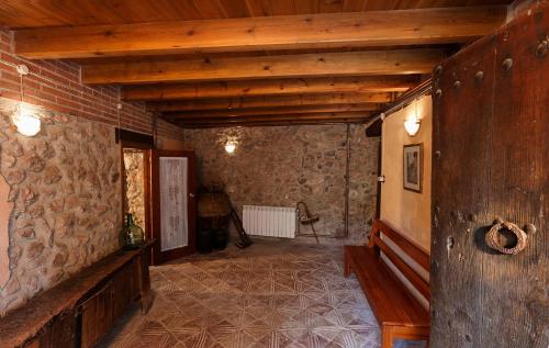 a hallway in a building with a stone wall at Cal Martí in Farena