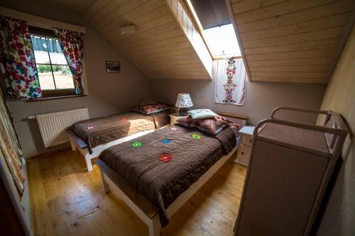 a small room with two beds in a tiny house at Chata drewniana Stefanówka in Ślemień