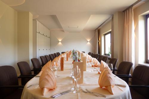 a long table in a room with chairs at Hotel Villa am Rhein in Andernach