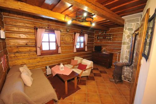 a living room of a log cabin with a couch and a table at Privat Beata in Hrabušice