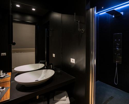 a bathroom with two sinks and a shower at Jb Relais Luxury in Rome