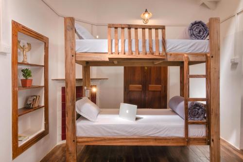 a room with two bunk beds with a laptop at Zostel Ooty in Ooty