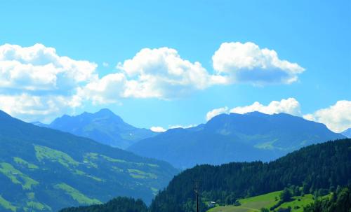 a view of a valley with mountains and clouds at Aparthotel AlpTirol in Kaltenbach