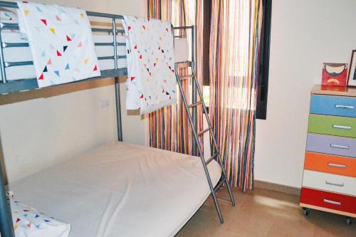 a bunk bed with a ladder in a room at Jardines de Las Marinas - Royal Suite in Denia