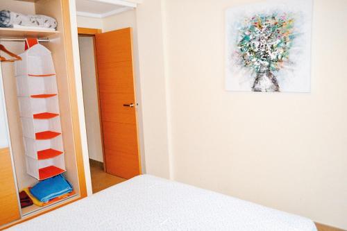 a bedroom with a bed and a painting on the wall at Jardines de Las Marinas - Royal Suite in Denia