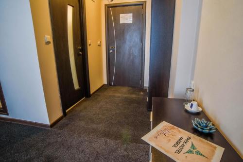 a room with a hallway with a door and a table at Park-Hotel Yambol in Yambol