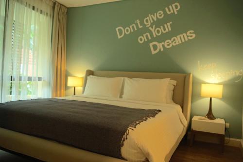 a bedroom with a bed with the words dont give up on your dreams at Marrakesh Residence 311 in Hua Hin