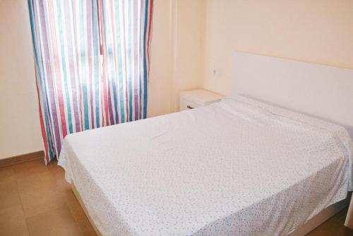 a white bed in a room with a window at Jardines de Las Marinas - Royal Suite in Denia