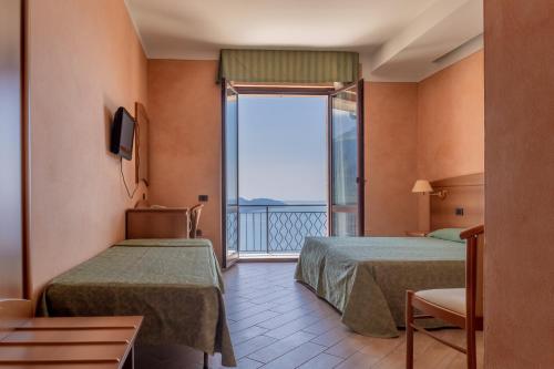 Un pat sau paturi într-o cameră la Park Hotel Zanzanù