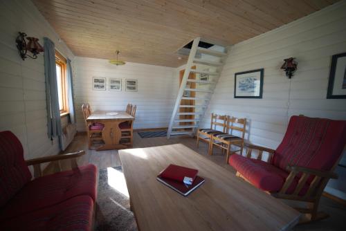 a room with a table and chairs in a cabin at Gullesfjord Camping in Gullesfjord