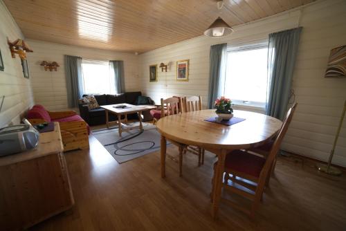 a living room with a wooden table and chairs at Gullesfjord Camping in Gullesfjord