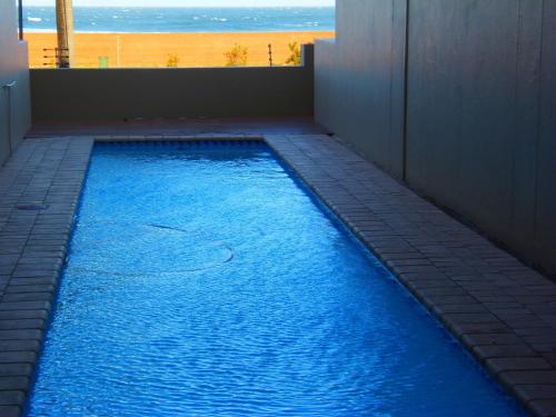 a swimming pool with a view of the beach at Margate Boulevard 302 in Margate