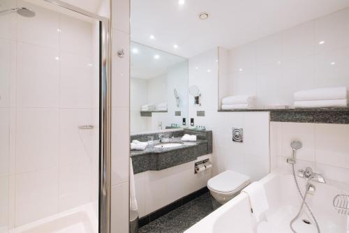 a bathroom with a sink, toilet and bathtub at Arora Hotel Gatwick/Crawley in Crawley