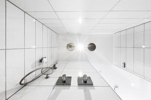 a bathroom with two sinks in a white room at Best Western Plus Hotel Fredericia in Fredericia