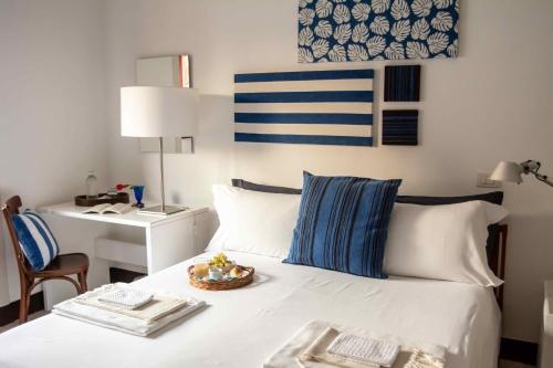 a bedroom with a bed with a table and a desk at Fuoridalguscio Home in Leuca