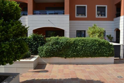 a hedge in front of a building at Jardines de Las Marinas - Royal Suite in Denia