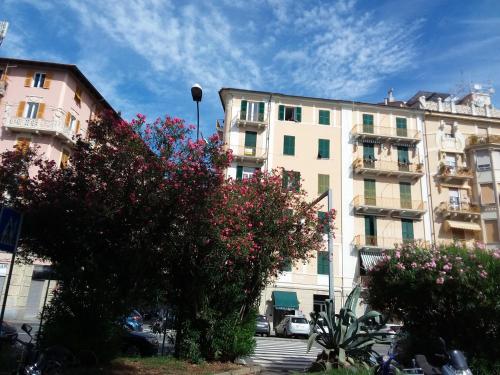 a building with a flowering tree in front of it at Skyline, Casa Vacanze in Savona