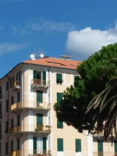 a tall white building with a red roof at Skyline, Casa Vacanze in Savona