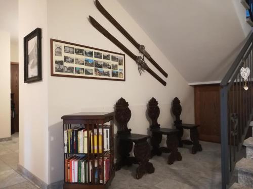 a staircase with a book shelf with books at Residence Orma in Alagna Valsesia