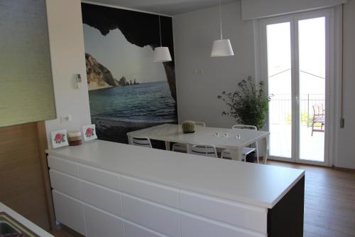 a kitchen with a white counter and a table at Affittacamere Le Fontanelle in Ancona