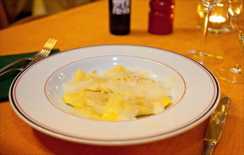 a white plate of food on a table at Le Vecchie Cantine in Chianni