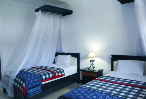 Ένα ή περισσότερα κρεβάτια σε δωμάτιο στο Aman Gati Hotel Lakey