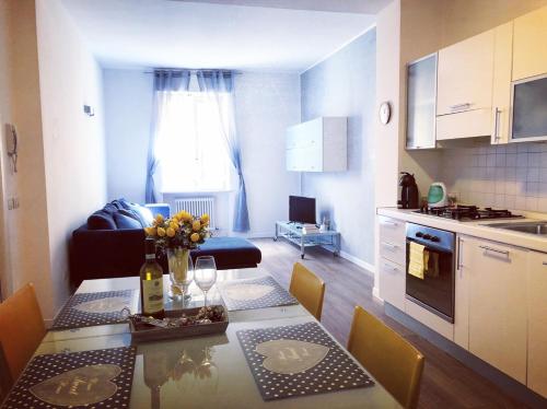 una cucina e un soggiorno con tavolo e fiori di Leoncino Apartment 2 a Verona
