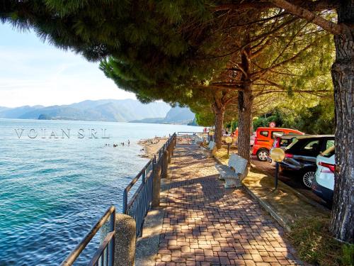 a beach with cars parked next to the water at 7 Lake Sweet Home in San Siro