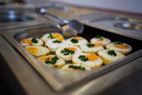 a tray of deviled eggs with parsley on top at Hotel Marttel in Karlovy Vary