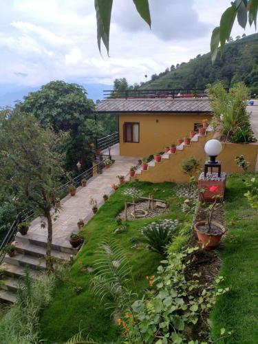 a house with stairs and plants in a yard at The Lapsi Tree in Nagarkot