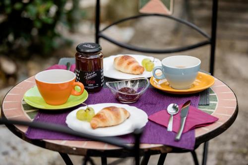 a table with two cups and plates of food on it at Miracolo di Mare Retro in Piran